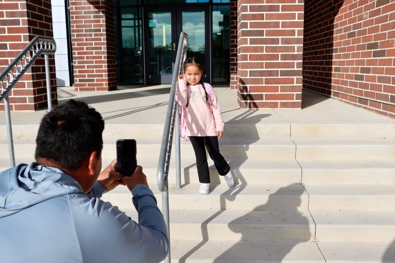 Jose Hernandez grabs a photo of his daughter, Brianna, who was starting her first day of kindergarten, on the steps of Lewes Elementary School Sept. 3. BILL SHULL PHOTO